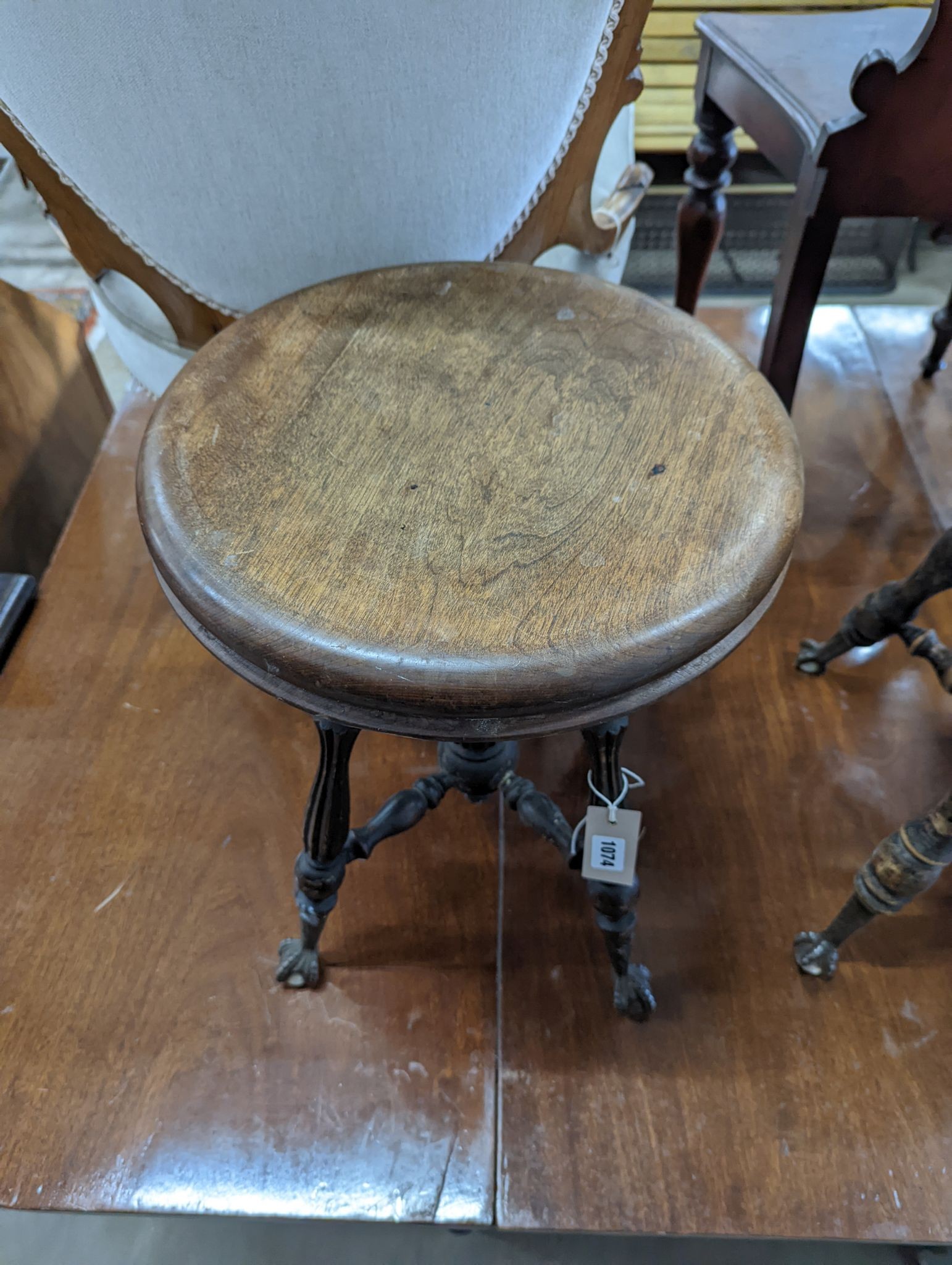 A near pair of Victorian mahogany and beech adjustable stools with revolving seats, larger diameter 36cm